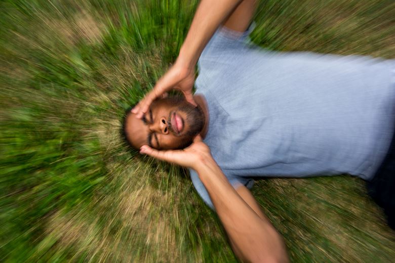 Man with concussion touching head