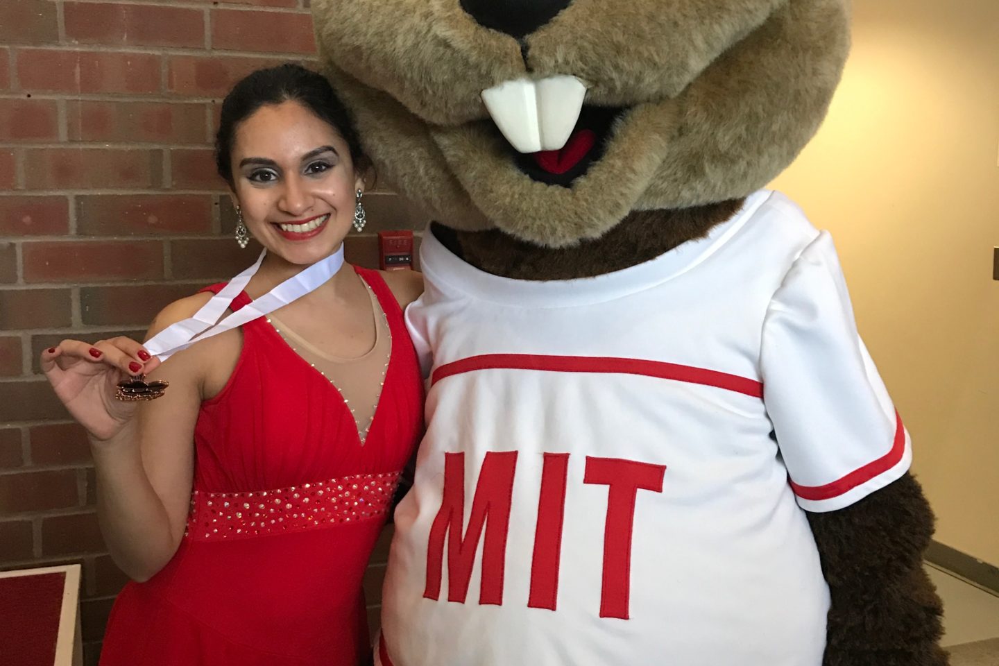 Figure skater with medal with Tim the Beaver