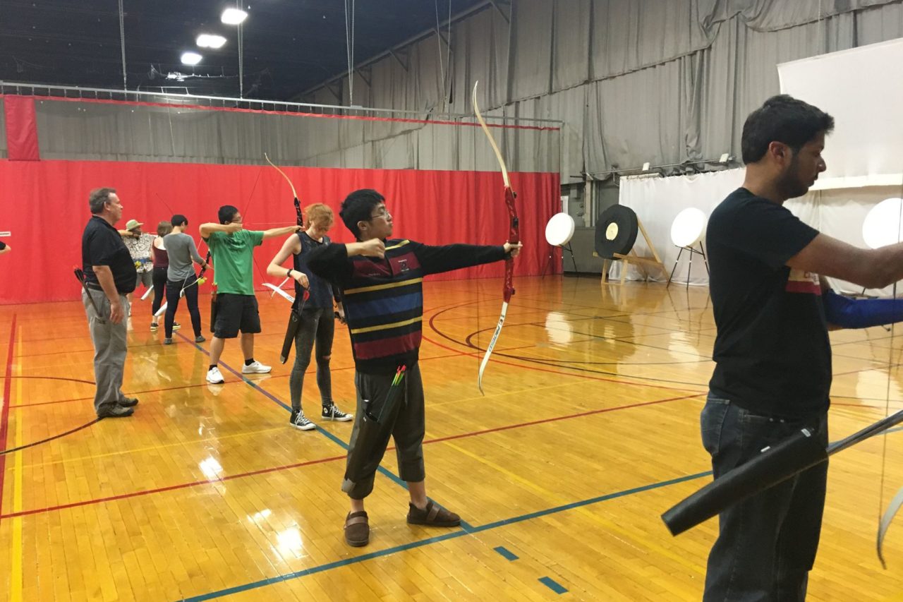 Students holding archery equipment