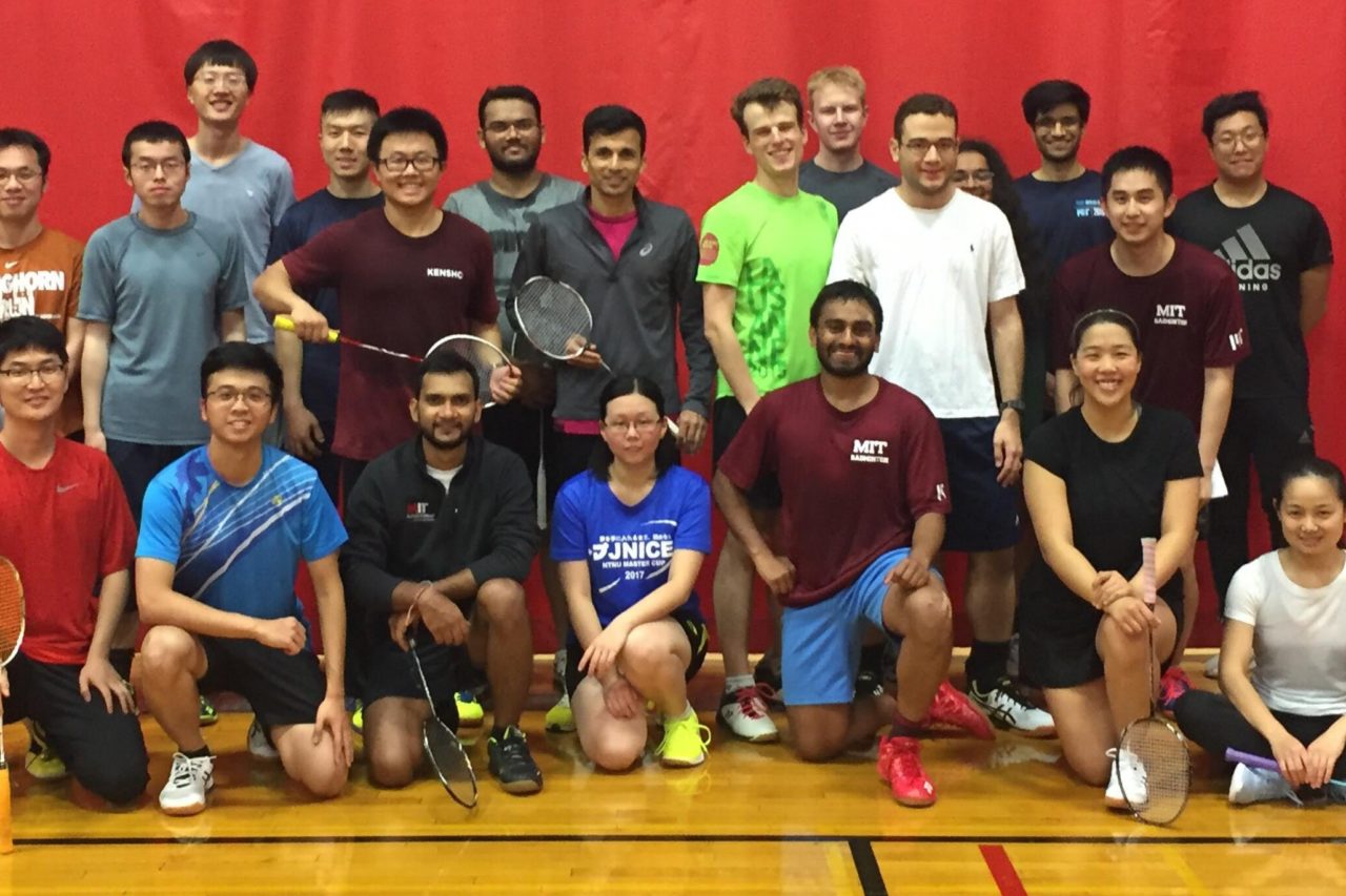 Students posing with badminton rackets