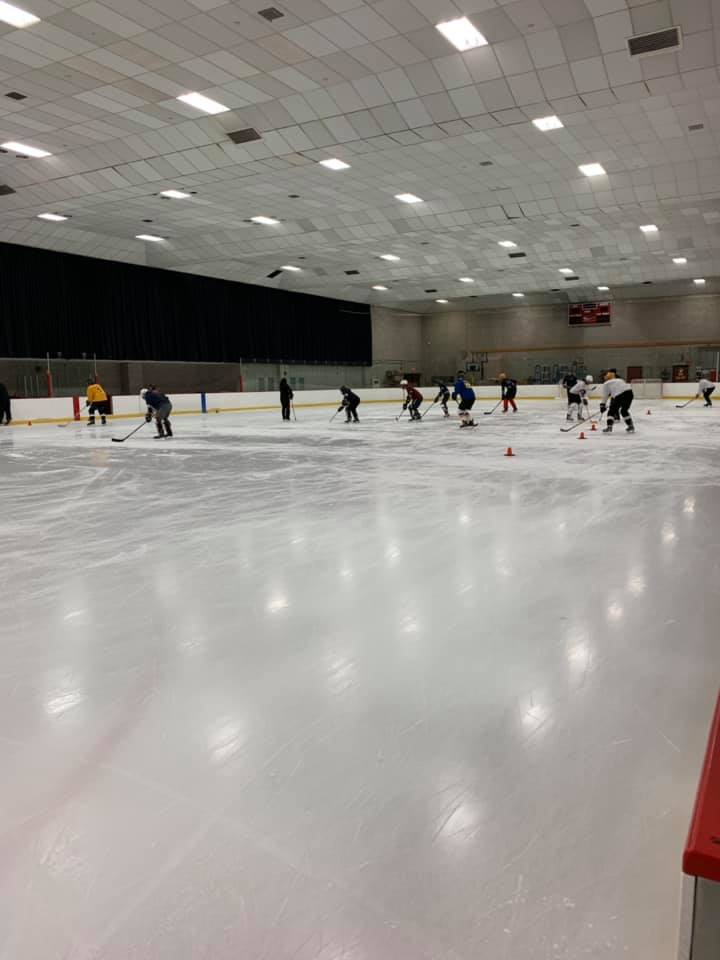 Skaters in the distance at a team skills clinic